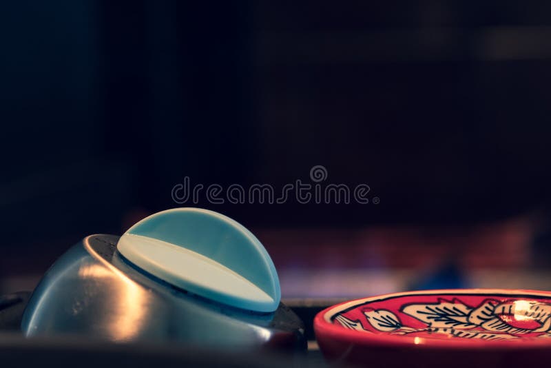 Egg timer on a kitchen surface, next to Asian theme large spoon - black background with copy space. stock photography Egg timer on a kitchen surface, next to Asian theme large spoon - black background with copy space. stock photography