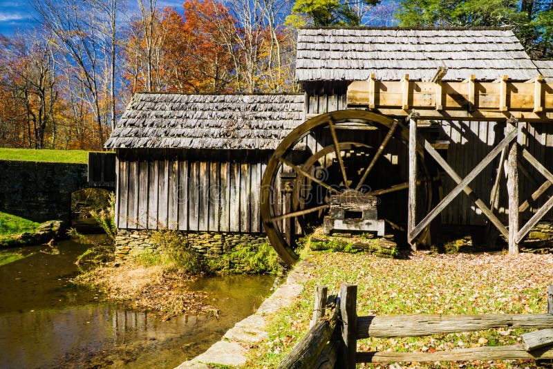 Floyd County, VA, October 28th: A photographer  taking autumn photos of Mabry Mill located on the Blue Ridge Parkway, Virginia, USA on October, 28th, 2019. Floyd County, VA, October 28th: A photographer  taking autumn photos of Mabry Mill located on the Blue Ridge Parkway, Virginia, USA on October, 28th, 2019.