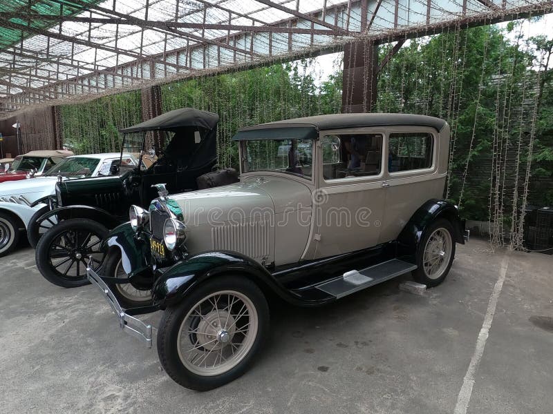 Side view of a parked Old Classic antique black and off white cream color custom rendition 1927-1931 Ford Model A. Vintage luxury auto. Kharkov, Ukraine - July 3, 2021. Side view of a parked Old Classic antique black and off white cream color custom rendition 1927-1931 Ford Model A. Vintage luxury auto. Kharkov, Ukraine - July 3, 2021