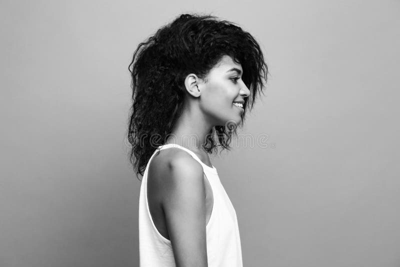 Side view portrait of beautiful attractive African American woman over yellow studio background. Copy Space and duotone. royalty free stock photography Side view portrait of beautiful attractive African American woman over yellow studio background. Copy Space and duotone. royalty free stock photography