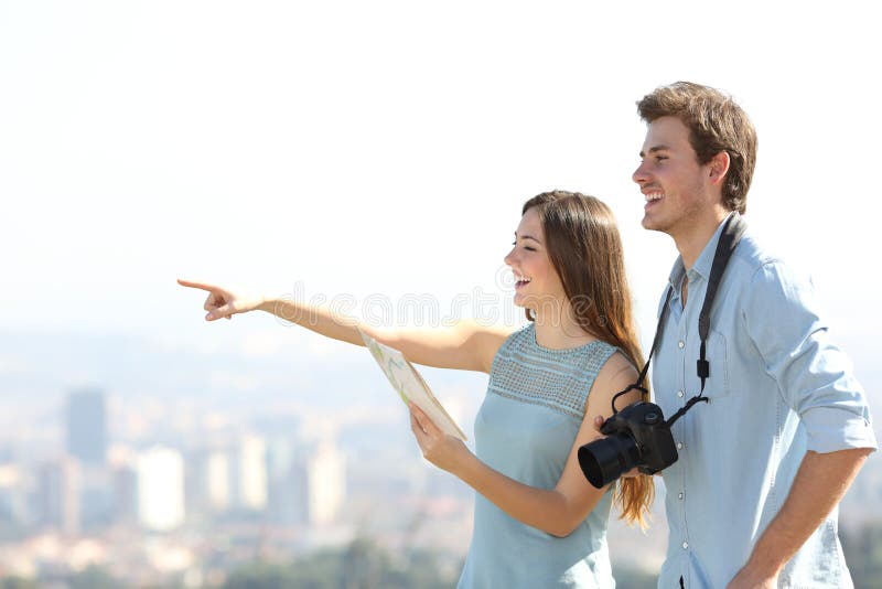 Happy tourists sightseeing in a city outskirts stock photos Happy tourists sightseeing in a city outskirts stock photos