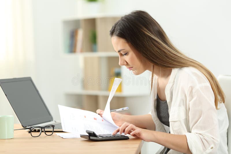 Woman calculating expenses at home