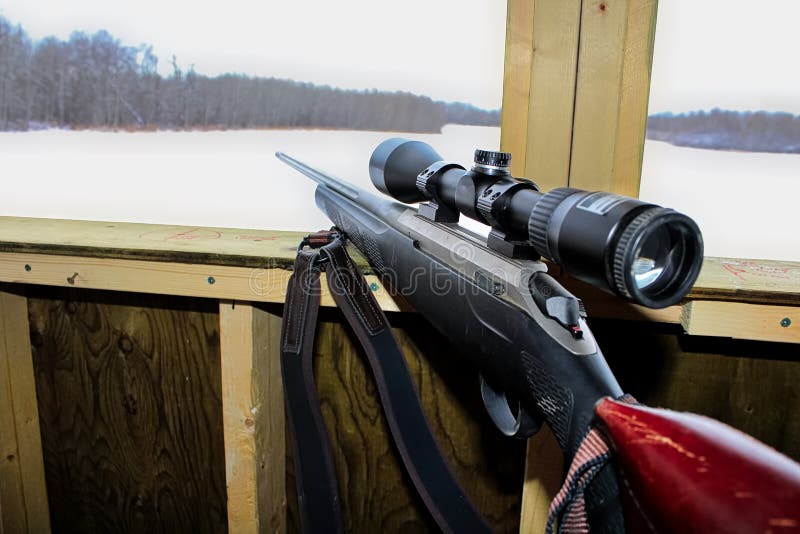 Side view of a rifle in a hunting blind stock images