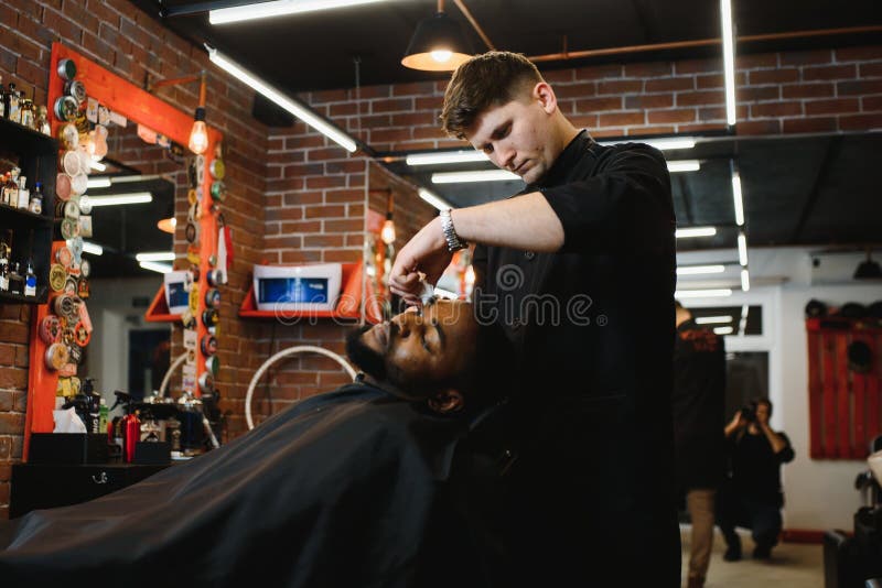 A Barber is Going through the Electric Cutting and Shaving Machine for the  Beard of an African-American Brazilian Boy Stock Image - Image of beauty,  business: 214303807