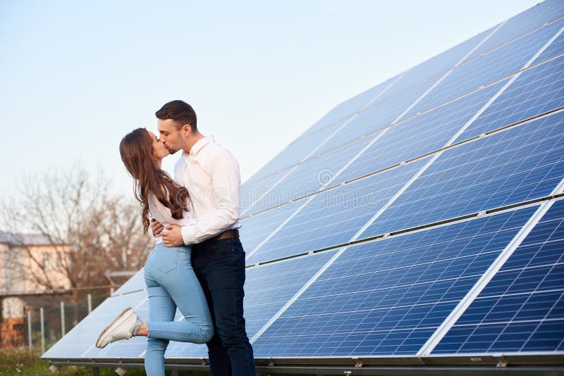 Kissing couple near solar panel