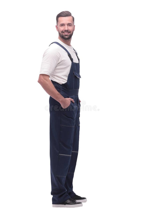 Side view. smiling man in overalls looking forward to copy space royalty free stock image Side view. smiling man in overalls looking forward to copy space royalty free stock image