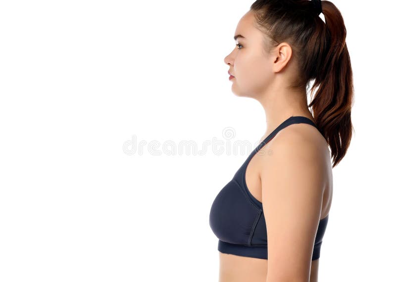 Side view of a tired female athlete on a white background. Side view of a young athletic woman with a ponytail hairstyle, wearing a sports top on a white royalty free stock image Side view of a tired female athlete on a white background. Side view of a young athletic woman with a ponytail hairstyle, wearing a sports top on a white royalty free stock image