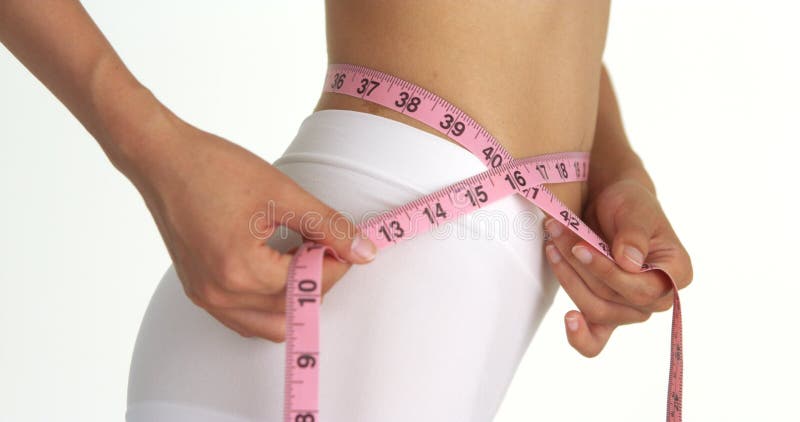 Side view of woman measuring waist