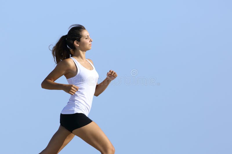 Side view of attractive and healthy fitness woman running along