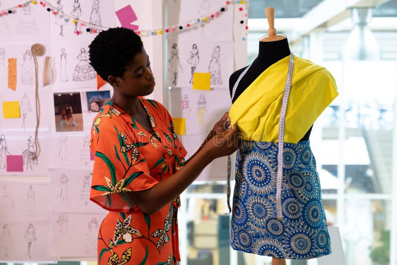Female Graphic Designer Examining Clothes on Mannequin in Design Studio ...