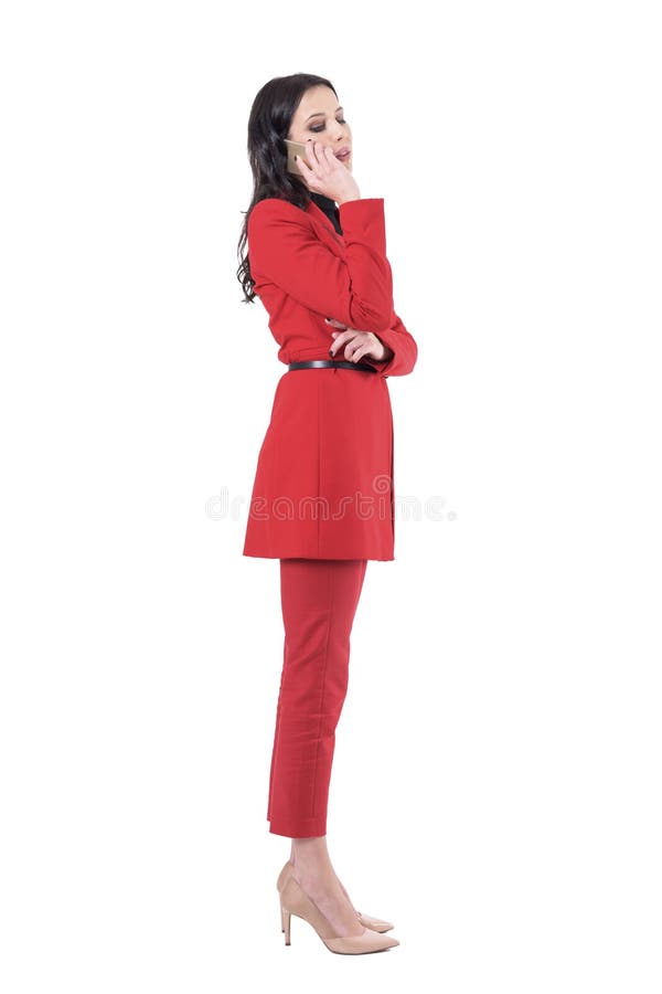 Side view of young business woman in suit talking on the phone and looking down. stock photos Side view of young business woman in suit talking on the phone and looking down. stock photos