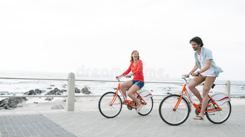 Caucasian Couple Riding Bicycle on Pavement Near Promenade Stock Photo ...