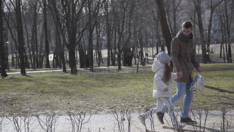 Side View of Young Caucasian Father Forcing Little Daughter To Go To School. Unwilling Cute Schoolgirl Walking To School Stock Footage - Video of parenthood, child: 182843872