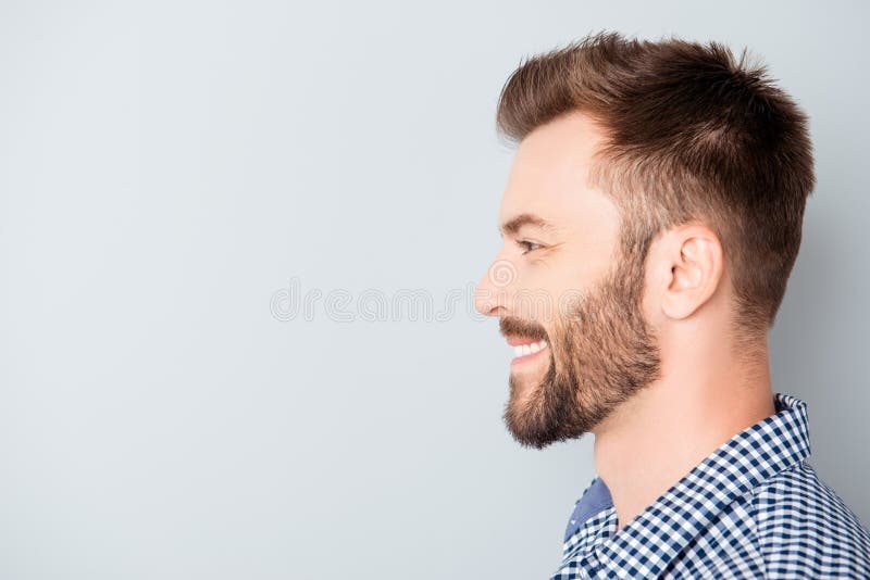 Side view of young happy smiling bearded man stock photography