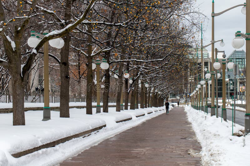 Sidewalk near Major's Hill Park in downtown Ottawa, Canada. Road with running person in winter royalty free stock photos