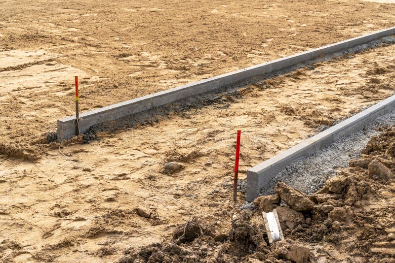 Concrete Curb Edging Being Cut with Expansion Joint in Cold Weather
