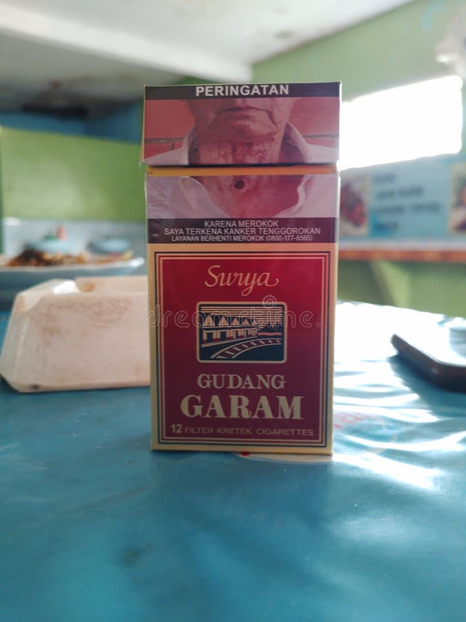 Sidoarjo, East Java, Indonesia - August 27, 2022 - Gudang Garam brand cigarettes containing 12 sticks stand on the table. Sidoarjo, East Java, Indonesia - August 27, 2022 - Gudang Garam brand cigarettes containing 12 sticks stand on the table