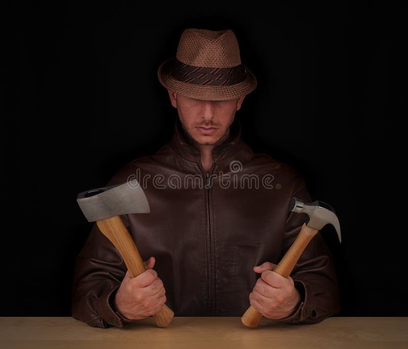 A man wearing a top hat, holding a hatchet and hammer in his hands. Black background. A man wearing a top hat, holding a hatchet and hammer in his hands. Black background