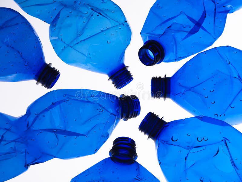 Seven blue plastic bottles crushed on white background. Seven blue plastic bottles crushed on white background