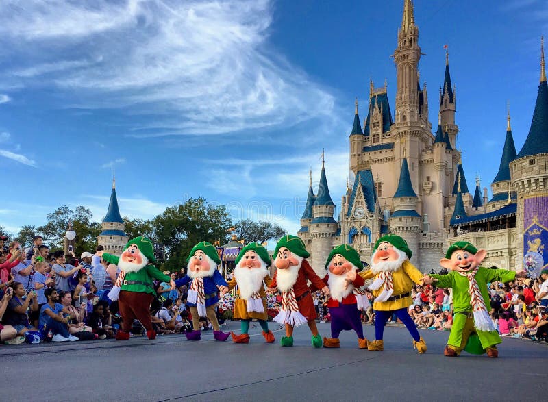 Crowd watching seven dwarfs singing and dancing in front of Cinderella Castle at Christmas holiday party,Walt Disney World Magic Kingdom,Orlando,Florida 2015. Crowd watching seven dwarfs singing and dancing in front of Cinderella Castle at Christmas holiday party,Walt Disney World Magic Kingdom,Orlando,Florida 2015