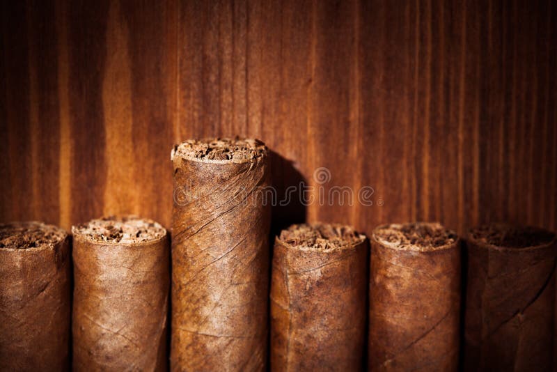 Cigars on wooden background, closeup view. Cigars on wooden background, closeup view