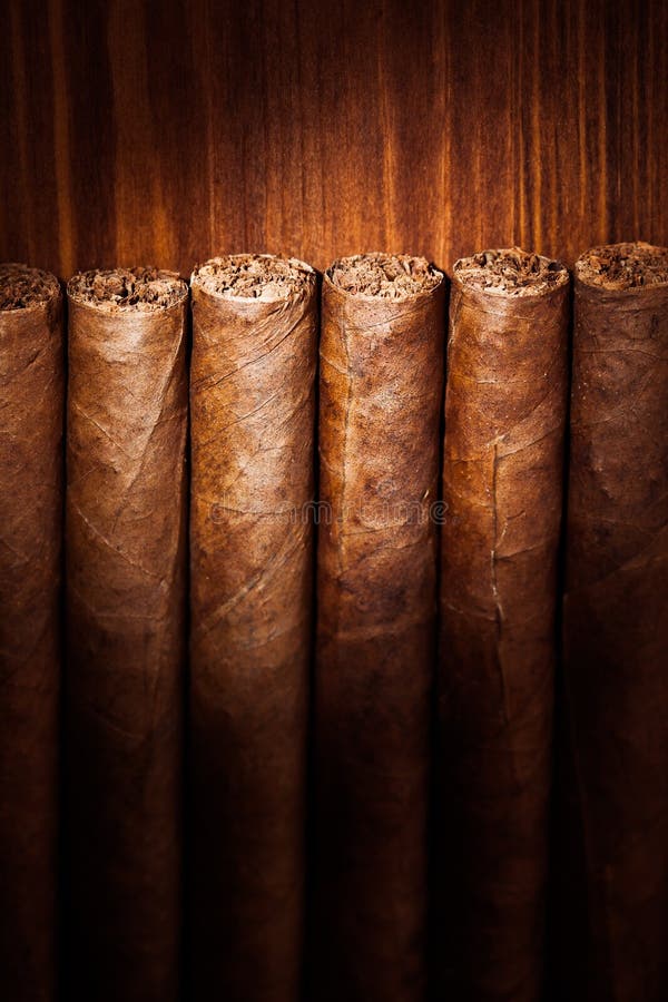 Cigars on wooden background, closeup view. Cigars on wooden background, closeup view