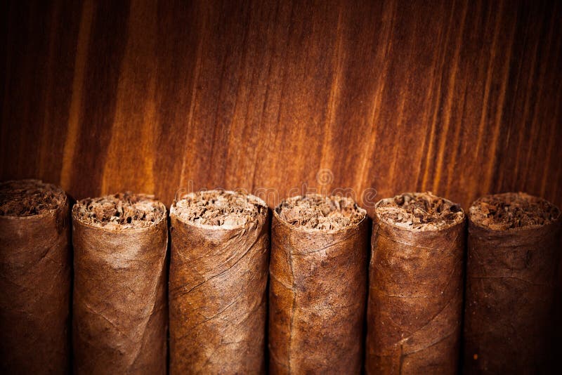 Cigars on wooden background, closeup view. Cigars on wooden background, closeup view