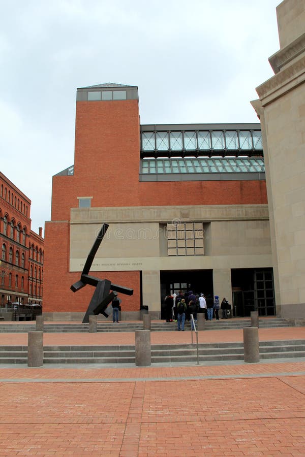 Visitors walking into the United States Holocaust Memorial Museum, with sculptures on the grounds,honoring millions of lives lost in the atrocities of WWII, Washington,DC,2015. Visitors walking into the United States Holocaust Memorial Museum, with sculptures on the grounds,honoring millions of lives lost in the atrocities of WWII, Washington,DC,2015.