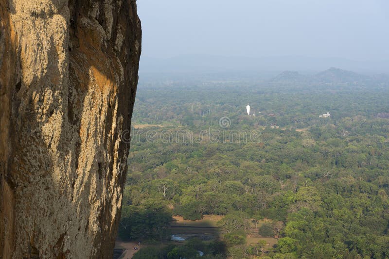 Rock fortress, view from the monument to the Buddha statue far in the distance showing the effect of scale. Rock fortress, view from the monument to the Buddha statue far in the distance showing the effect of scale.