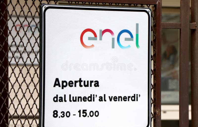 Sign of an Enel office with opening hours to the public, an Italian energy multinational stock photos