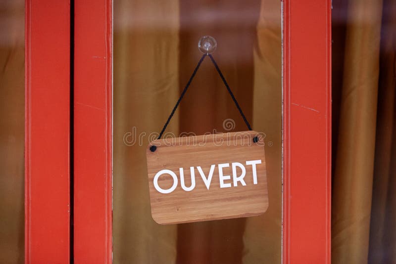 Close-up on a sign saying in French Entrez nous sommes ouverts, meaning  in English Come in we're open Stock Photo - Alamy