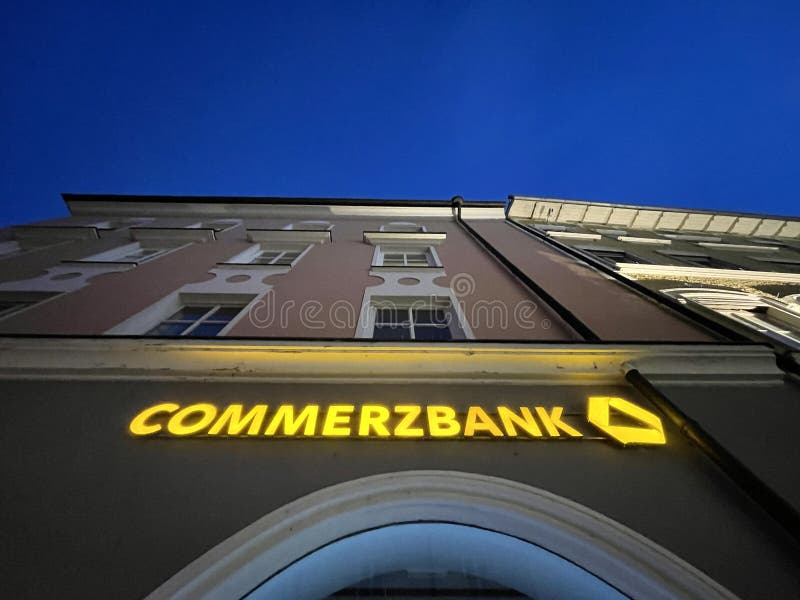 Sign on a german Commerzbank bank during night time - copy space above and under the sign. Sign on a german Commerzbank bank during night time - copy space above and under the sign