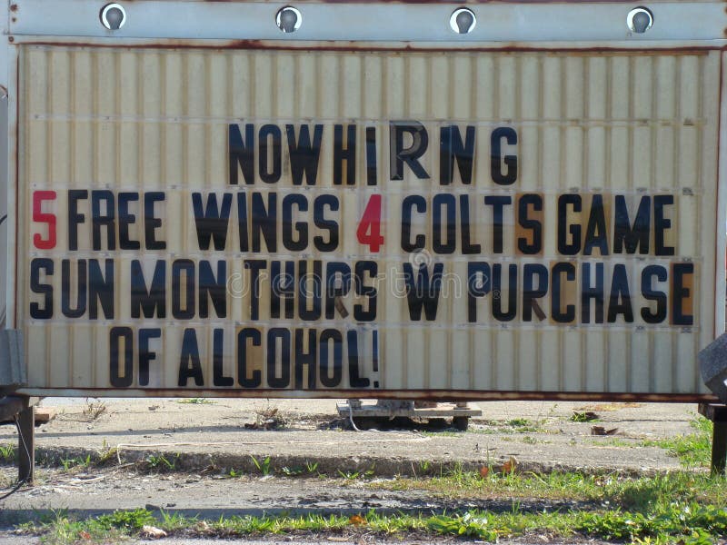 Sign that reads, Now hiring 5 free wings stock photos Sign that reads, Now hiring 5 free wings stock photos