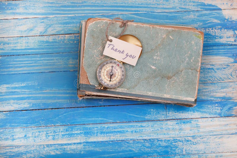 Sign Thank You and Compass on Old Book Vintage Style Stock Image