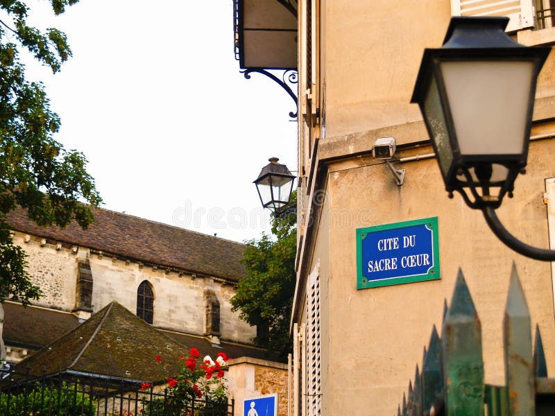 Sign on wall Cite du Sacre Coeur meaning quote or mention of Sacred Heart