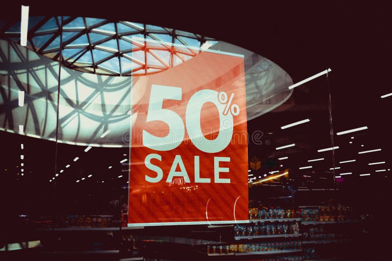 Signboard with the inscription Sale 50 in the fashion store. Image of a sale ad in a clothing store window stock photography Signboard with the inscription Sale 50 in the fashion store. Image of a sale ad in a clothing store window stock photography