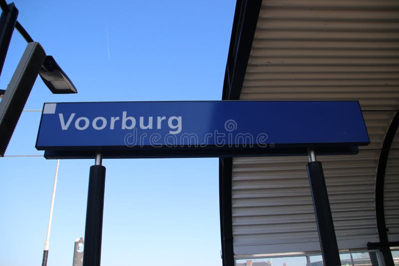 Signe bleu et blanc Voorburg de nom sur la plate-forme de la gare ferroviaire aux Pays-Bas image libre de droits Signe bleu et blanc Voorburg de nom sur la plate-forme de la gare ferroviaire aux Pays-Bas image libre de droits