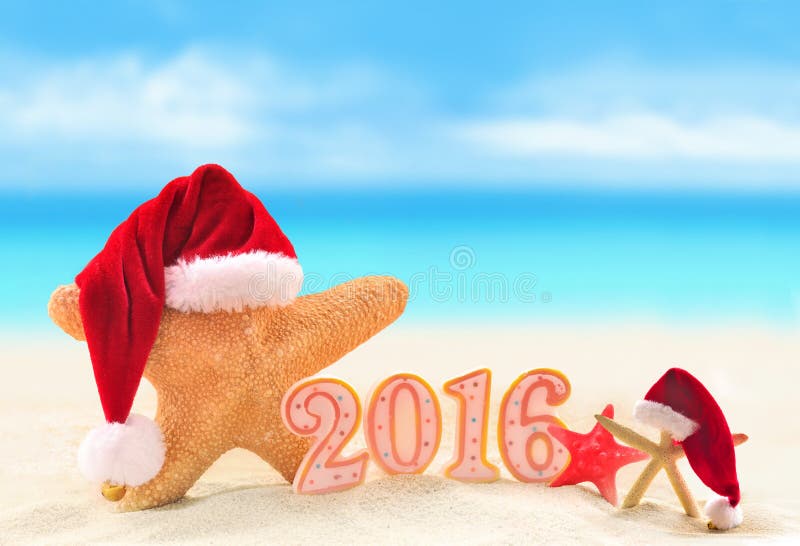 New year 2016 sign with starfish in Santa Claus hat on a beach sand. New year 2016 sign with starfish in Santa Claus hat on a beach sand