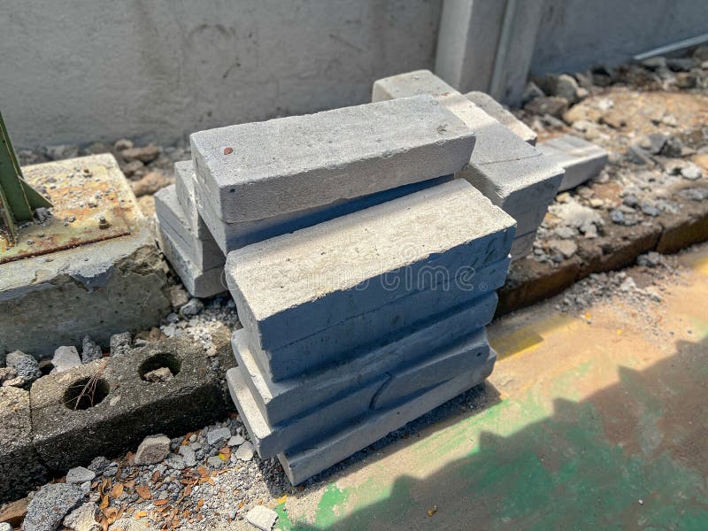 A significant pile of sturdy concrete blocks is neatly stacked on top of each other on the solid ground surface, forming a robust structure. Load structural stock images, royalty-free photos and pictures