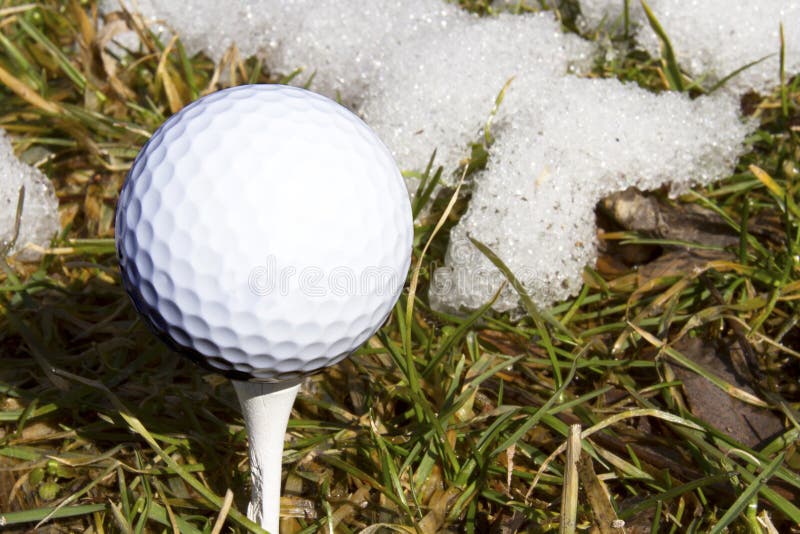 Signs of Spring, Golf Ball on Tee with Snow stock photos Signs of Spring, Golf Ball on Tee with Snow stock photos