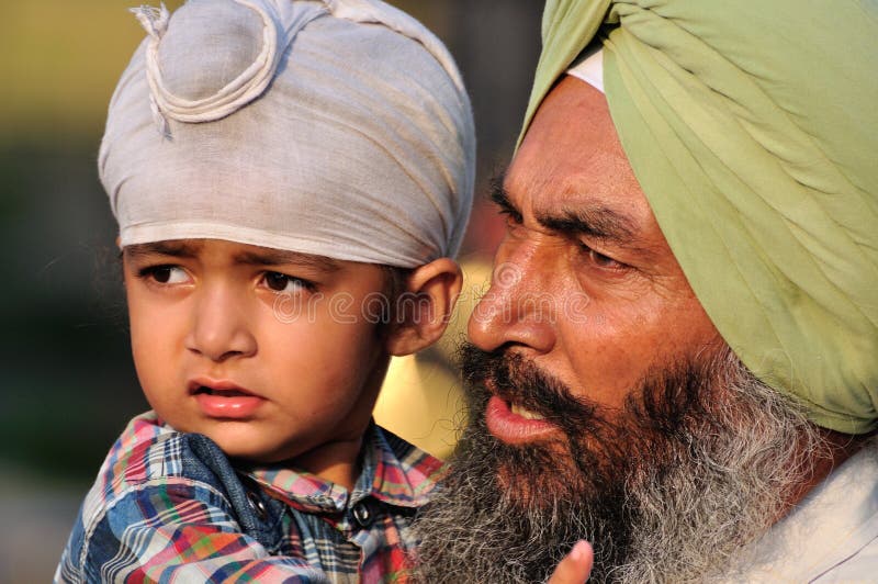 Sikh Father and Son at the ceremonial of the border between India and Pakistan. Sikh Father and Son at the ceremonial of the border between India and Pakistan.