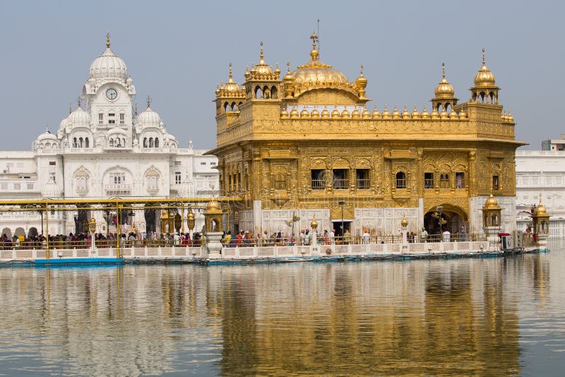 AMRITSAR, INDIA - SEPTEMBER 26, 2014: Unidentified Sikhs and indian people visiting the Golden Temple in Amritsar, Punjab, India. Sikh pilgrims travel from all over India to pray at this holy site. AMRITSAR, INDIA - SEPTEMBER 26, 2014: Unidentified Sikhs and indian people visiting the Golden Temple in Amritsar, Punjab, India. Sikh pilgrims travel from all over India to pray at this holy site