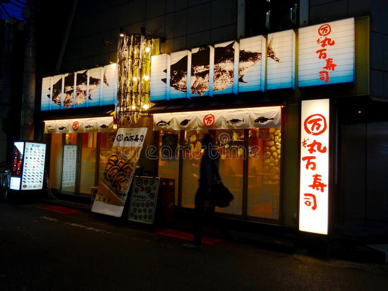 Sikt av en typisk japansk sushirestaurang p? natten i Osaka, Japan fotografering för bildbyråer Sikt av en typisk japansk sushirestaurang p? natten i Osaka, Japan fotografering för bildbyråer