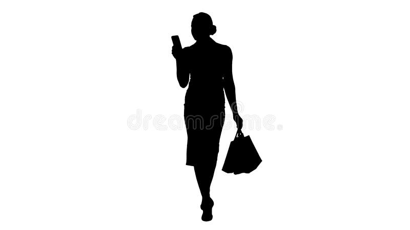 Silhouet Mooie aantrekkelijke vrouwen die in smartphone kijken en het winkelen zakken houden terwijl het lopen stock foto Silhouet Mooie aantrekkelijke vrouwen die in smartphone kijken en het winkelen zakken houden terwijl het lopen stock foto
