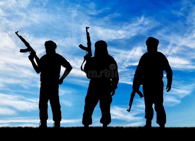 Concept of terrorism. Silhouette of three terrorists with a weapon against a background of blue sky. Concept of terrorism. Silhouette of three terrorists with a weapon against a background of blue sky