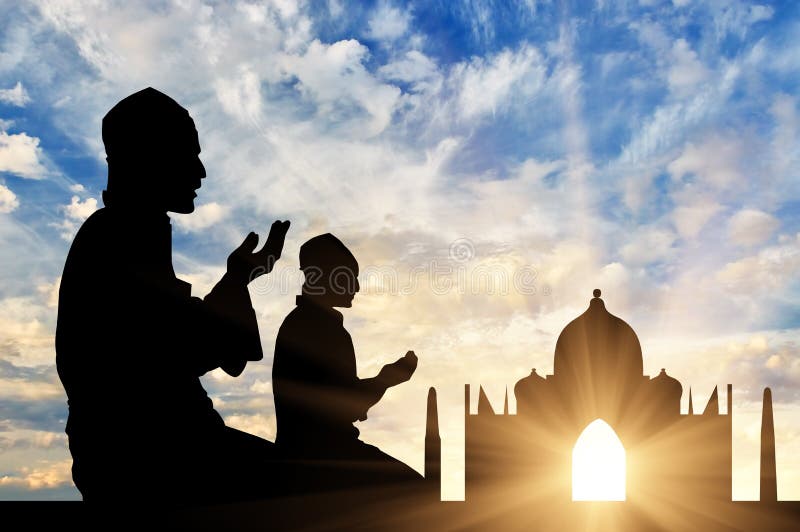 The concept of religion Islam. Silhouette of two men praying at sunset in the background Mosque. The concept of religion Islam. Silhouette of two men praying at sunset in the background Mosque