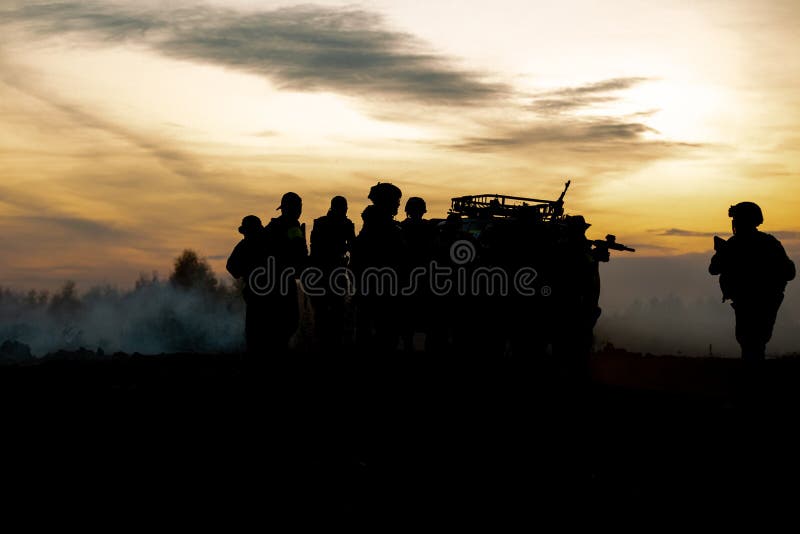 Silhouette action soldiers walking hold weapons the background is smoke and sunset and white balance ship effect dark