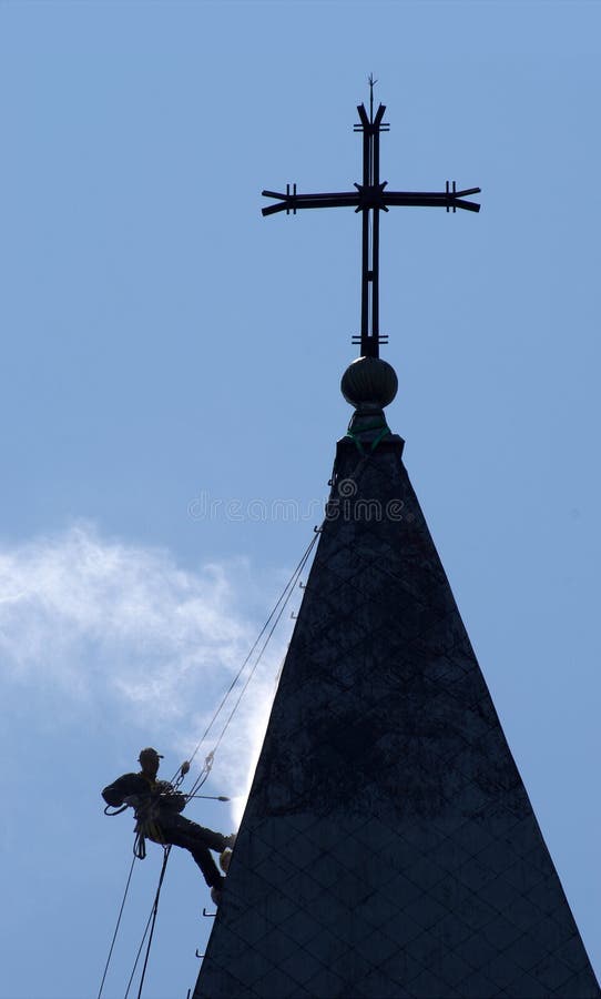 Silhouette of the alpinist cleans church roof royalty free stock image Silhouette of the alpinist cleans church roof royalty free stock image