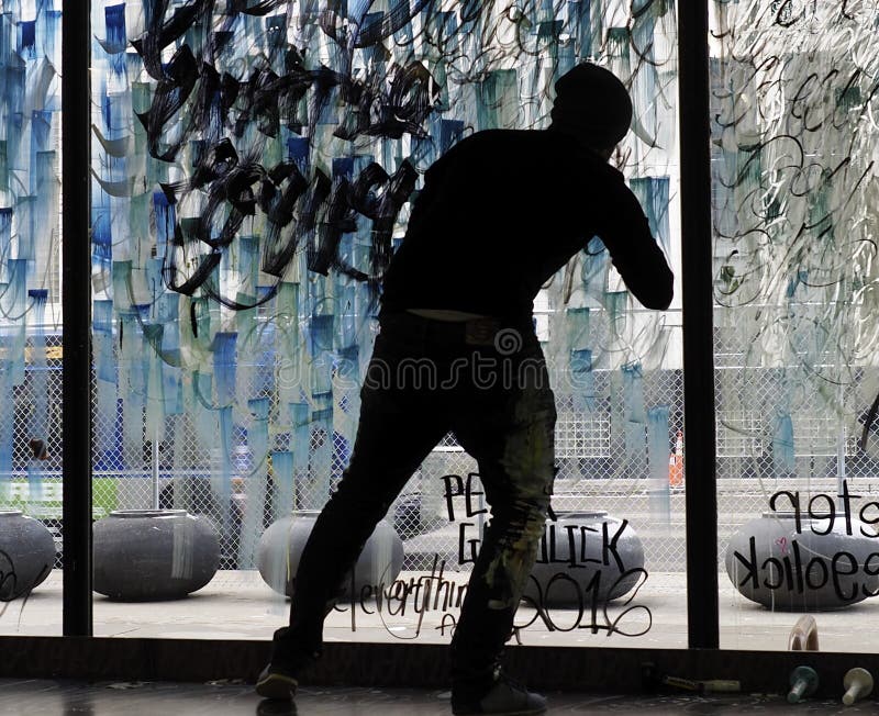 Silhouette Of Artist Painting Glass Window