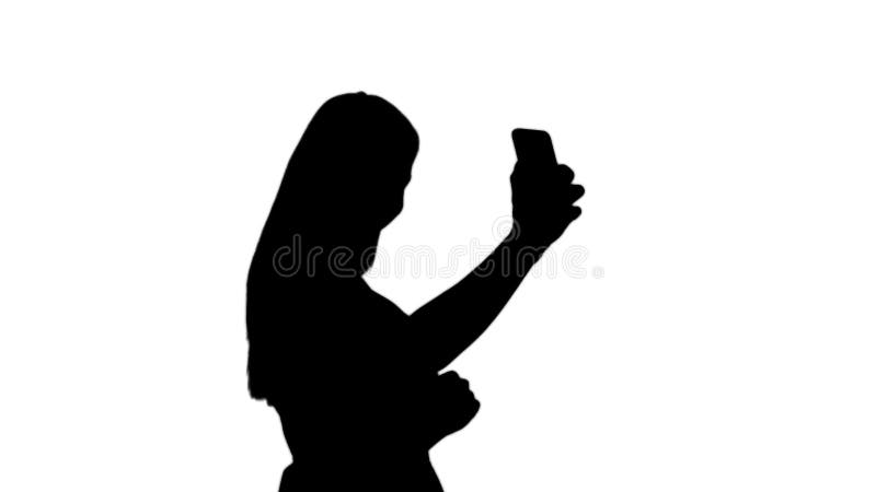 Silhouette Beautiful young woman doing selfies.